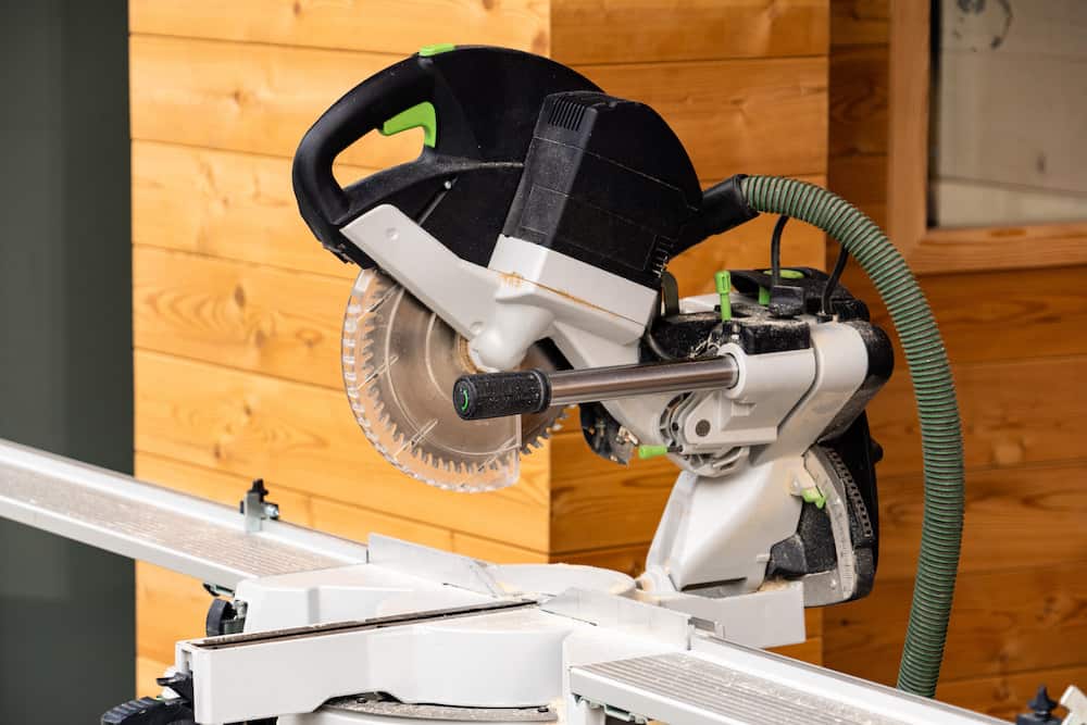 Sliding compound mitre saw. Electric tool for construction of wooden house. tips on how to use a sliding miter saw